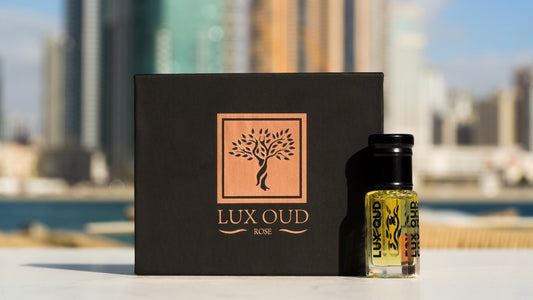 Lux Oud branded presentation and perfume oil bottle photographed in coastal light; illustrative image, see listing for exact set contents